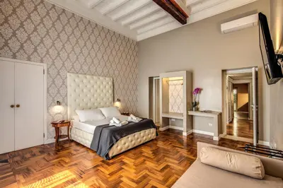 a bedroom with a bed and a living room at The Spanish steps apartment 67 in Rome