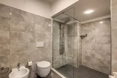 a bathroom with a shower and a toilet and a sink at The Spanish steps apartment 67 in Rome