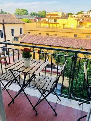 a wooden bench sitting on top of a balcony at S.Apollonia Suite Trastevere in Rome