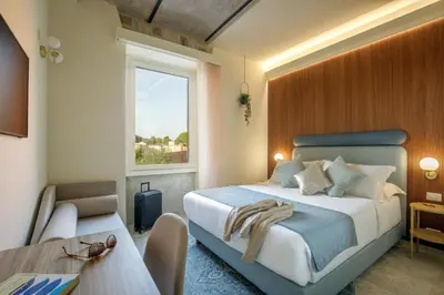 a bedroom with a large bed and a window at Rome for Two in Rome