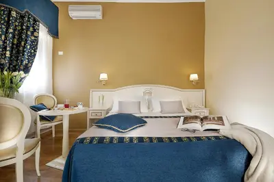 a bedroom with a bed with two books on it at Dimora Degli Dei in Rome