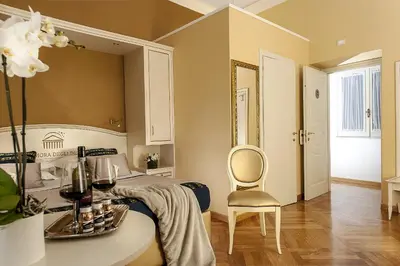 a bedroom with a bed with a table and a chair at Dimora Degli Dei in Rome