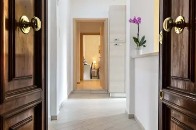 a hallway with an open door with a hallway leading into a room at Rome Central Rooms in Rome