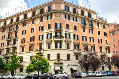 a large building with cars parked in front of it at Rome Central Rooms in Rome