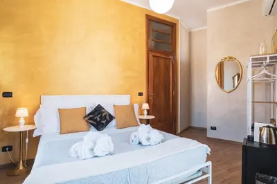 a bedroom with a white bed with towels on it at Golden Rooms Piazza di Spagna in Rome