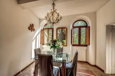 a dining room with a glass table and chairs at Campo di Fiori 2 bedroom Via Giulia in Rome
