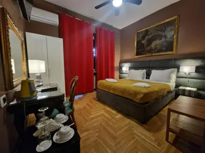 a lamp attached to a wall next to a bed at Sweet Home Parioli in Rome