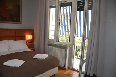 a mirror over a desk with a bed in a hotel room at Sweet Home Parioli in Rome