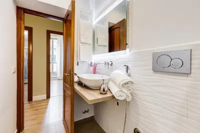 a bathroom with a sink and a mirror at Repubblica Exclusive Apartment in Rome