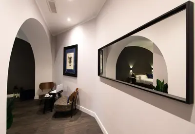 a living room with a large mirror on the wall at Lungotevere Ripa in Rome