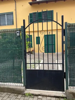 a gate to a house with green shutters on it at Appiolatino - Il Fenicottero in Rome