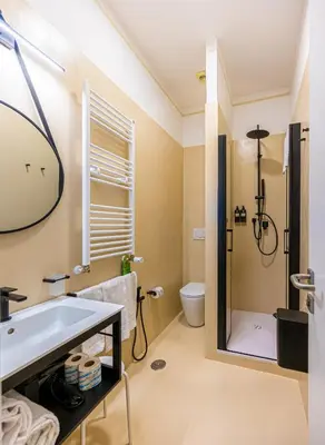 a bedroom with a canopy bed with white sheets at Four Rivers Suites in Rome