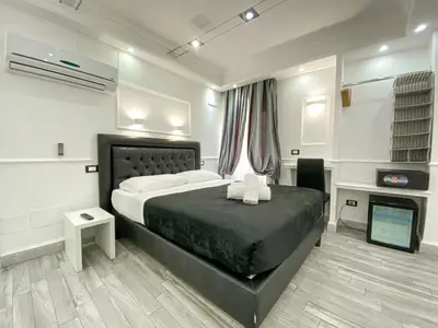 a bedroom with a bed and a television in it at Locanda Parlamento in Rome