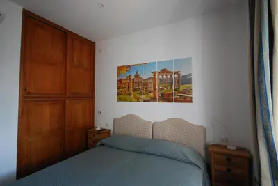 a bedroom with a bed and a painting on the wall at L'Oasi al Pigneto - Guest house in Rome