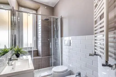 a bathroom with a toilet and a sink and a shower at Domus Heroas near Vatican in Rome