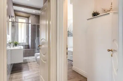 a bathroom with a toilet and a sink and a mirror at Domus Heroas near Vatican in Rome