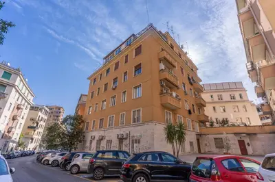 a tall building with cars parked in front of it at Domus Heroas near Vatican in Rome