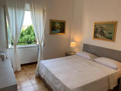 a bedroom with a large bed and a window at Arion Holiday Home in Rome