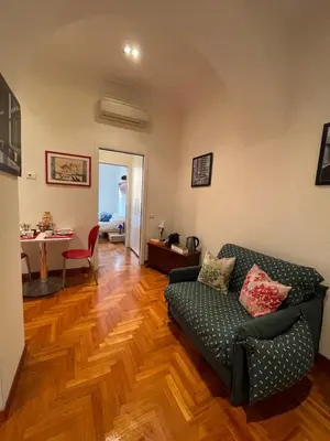 a living room with a couch and a table at ColosseoDreamApartment in Rome