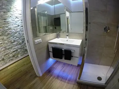 a bathroom with a sink and a shower at Poliziano Apartment in Rome