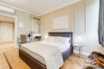 a bedroom with a large bed and a desk at Mellini Palace Suites by Premium Suites Collection in Rome
