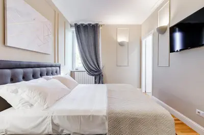 a bedroom with a white bed and a television at Mellini Palace Suites by Premium Suites Collection in Rome