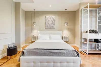 a bedroom with a white bed and a white shelf at Mellini Palace Suites by Premium Suites Collection in Rome