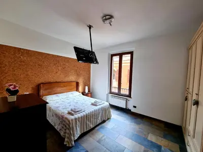 a bedroom with a bed and a desk and a window at La Casa nel Borgo in Rome