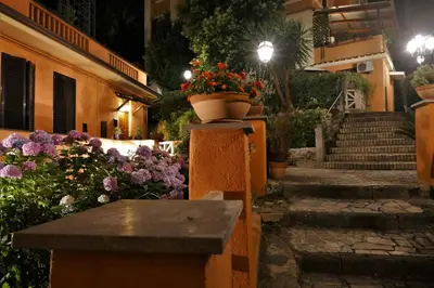 a group of flowers in a courtyard at night at La Casa nel Borgo in Rome