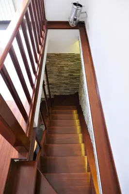 a stairwell with a wooden staircase with a light on it at La Casa nel Borgo in Rome
