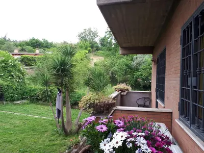 a balcony with flowers on the side of a house at B&B Papa Leone Countryrooms in Rome