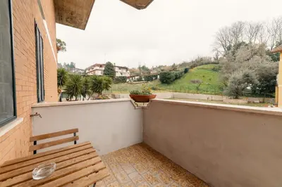 a wooden bench sitting on the balcony of a building at B&B Papa Leone Countryrooms in Rome