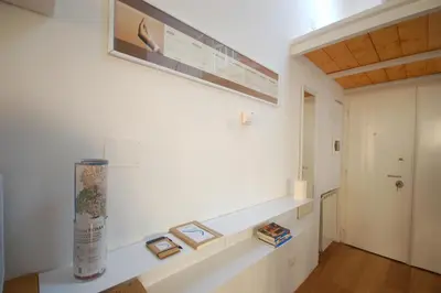 a room with a white wall with three pictures on it at LOST&FOUND in Trastevere in Rome