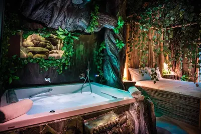 a bath tub in a room with a tree stump at MagicSuite Guest House Roma Portuense in Rome