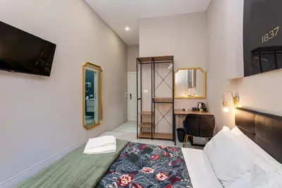 a bedroom with a bed and a desk in a room at Empire Suites in Rome