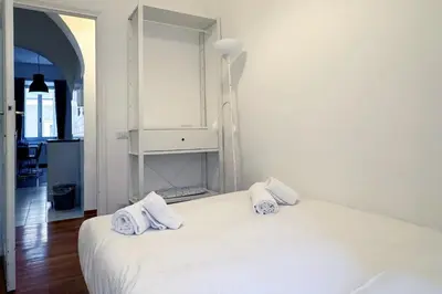 a white bedroom with a bed with towels on it at JHHIT San Pietro Modern Suite in Rome