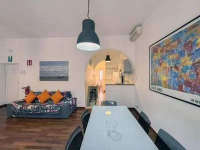 a living room with a table and a couch at JHHIT San Pietro Modern Suite in Rome