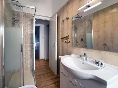 a bathroom with a sink and a shower at JHHIT Tuscolana Suite 03 with Terrace in Rome