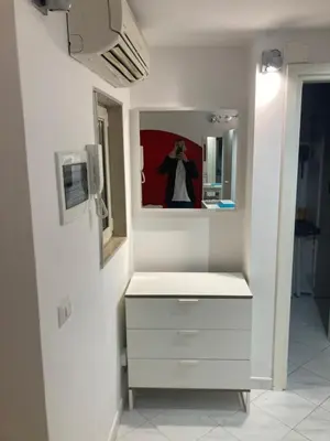a bathroom with a white sink and a mirror at Urbana Colosseo Boutique Apartment in Rome