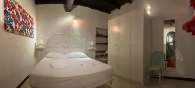 a bedroom with a white bed in a room at Urbana Colosseo Boutique Apartment in Rome