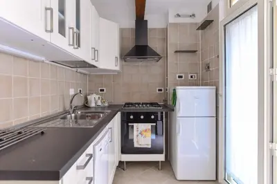 a kitchen with a sink and a refrigerator at Urbana Colosseo Boutique Apartment in Rome