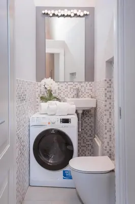 a bathroom with a washing machine and a sink at Margana Tower in Rome