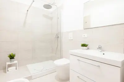 a bathroom with a shower and a toilet and a sink at White Flat Labicana in Rome