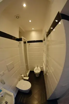 a bathroom with two toilets and a sink and a shower at Petit Bijou de Rome Vatican-Trastevere in Rome