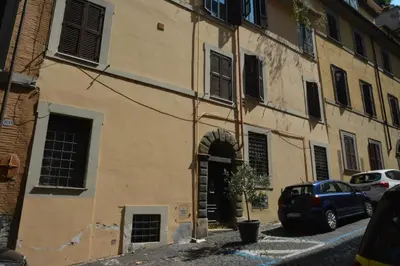an old building with an archway in a street at Petit Bijou de Rome Vatican-Trastevere in Rome