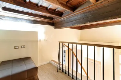 a staircase in a loft with wooden ceilings at Pantheon Hedonism in Rome