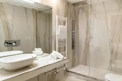 a white bathroom with a sink and a shower at Pantheon Hedonism in Rome
