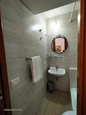 a bathroom with a sink and a mirror at Rossi Hotel in Rome