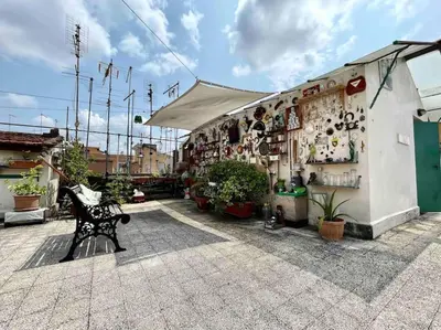 a store with a bench in front of a building at Ugo Foscolo in Rome
