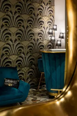 a dressing room with a blue chair and a mirror at Mi Hotel Home in Rome